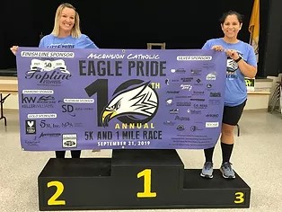 holding up eagle pride race banner